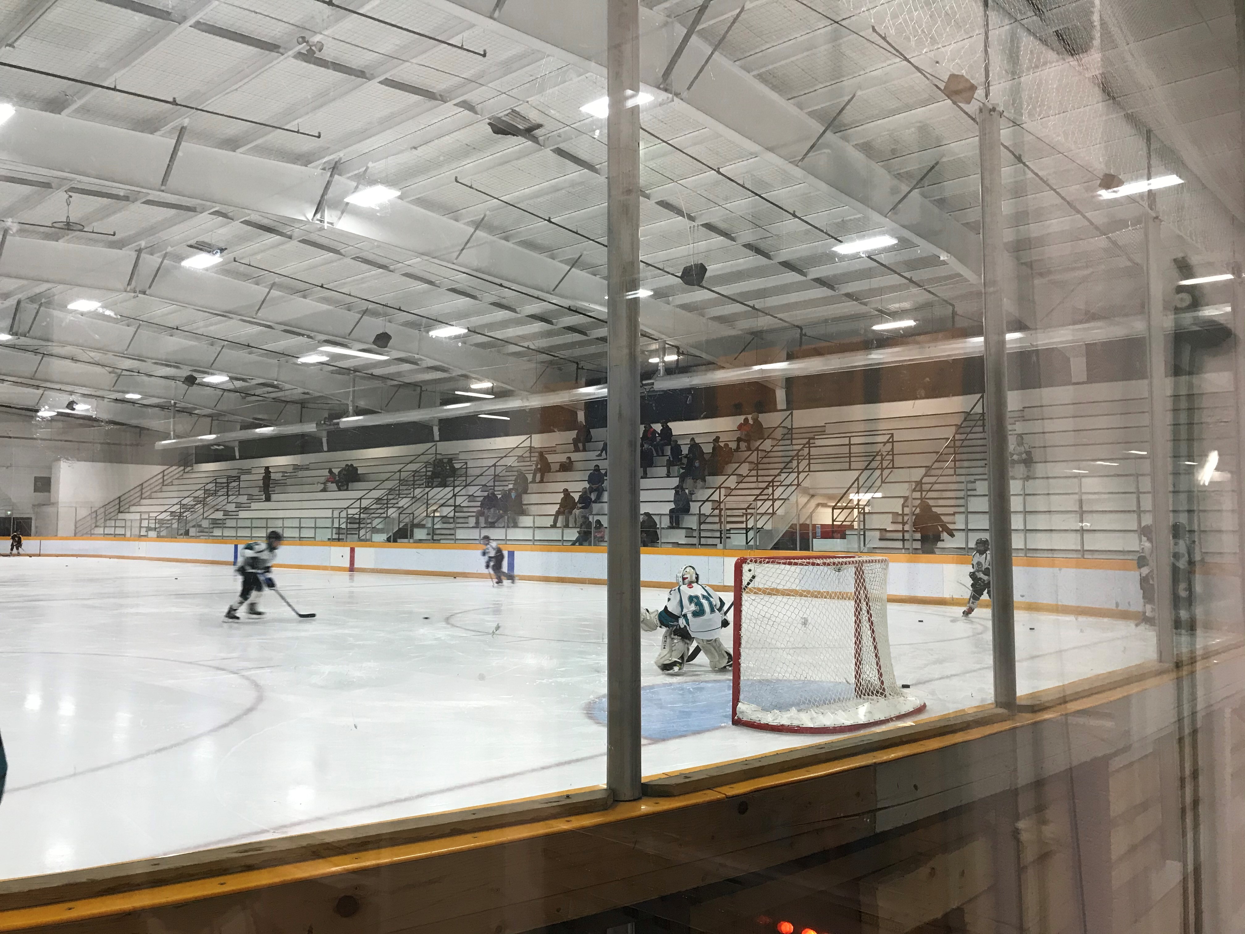 Hockey Players Skating on Ice Rink